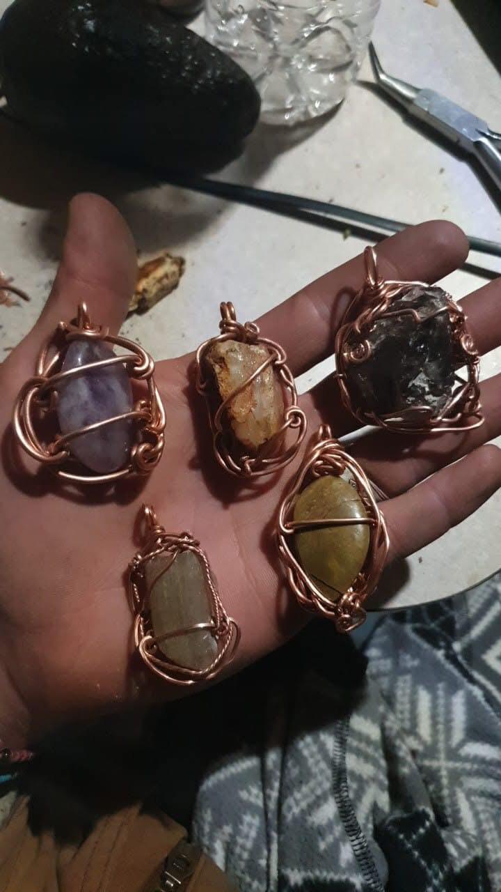 Collection of five copper wire-wrapped crystal pendants